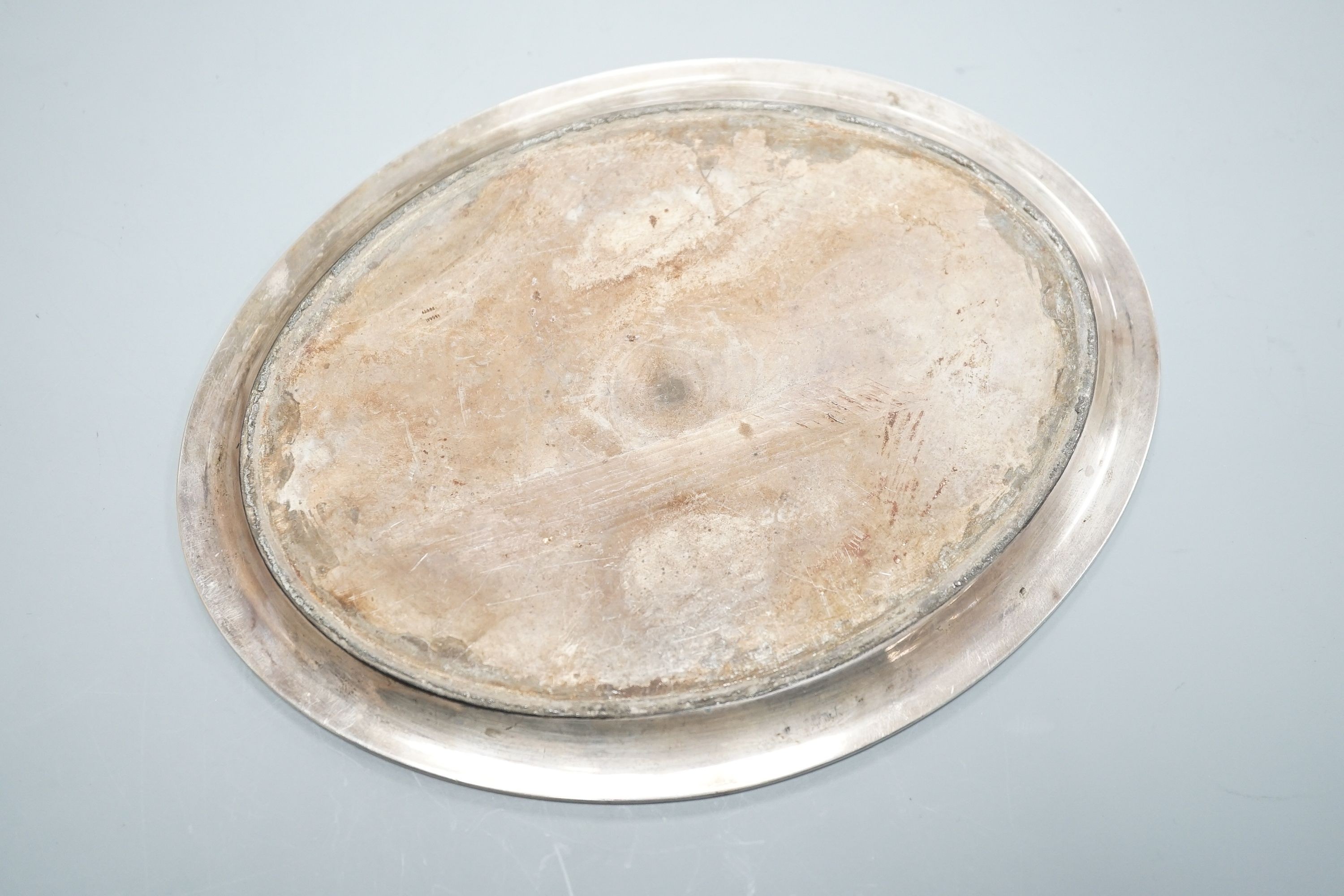 A George III silver oval teapot stand, with tired engraved decoration and wooden base, London, 1790, marks quite rubbed, 16.9cm.